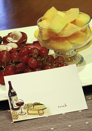 Anniversary dinner cards are painted with grapes while a 50th wedding 