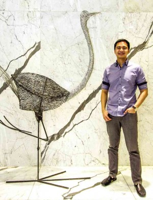 GAB Perez stands next to an ostrich metal sculpture by Ann Pamintuan in the lobby of Privato Hotel. PHOTOS BY LEO SABANGAN