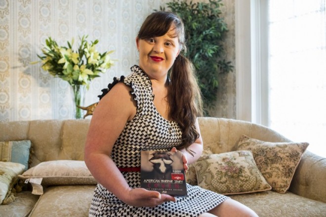 Jamie Brewer holds an "American Horror Story: Coven" Blu-Ray to celebrate its release at Buckner Mansion on Oct. 11, 2014, in New Orleans, Louisiana. AFP