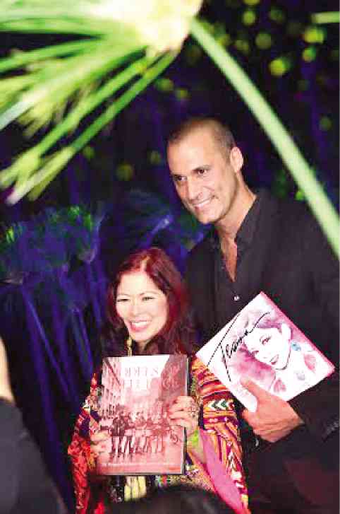 Lifestyle columnist Tessa Prieto trades books and poses with Nigel Barker during his book launch 