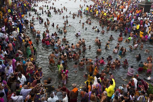 Hindu devotees take holy dip in the River Godavari on the first official day of bathing as part of Kumbh Mela celebrations in Nasik, India, Wednesday, Aug. 26, 2015. Hindus believe that sins accumulated in past and current lives require them to continue the cycle of death and rebirth until they are cleansed. Bathing in sacred waters on the most auspicious day of the Kumbh festival, or Pitcher Festival, believers say rids them of their sins. (AP Photo/Bernat Armangue)