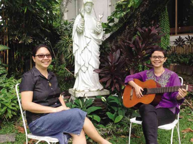 SINGING of Him. Cenacle Sisters Susay Valdez and Bubbles Bandojo in the Cenacle Retreat House’s garden ALYA B.HONASAN