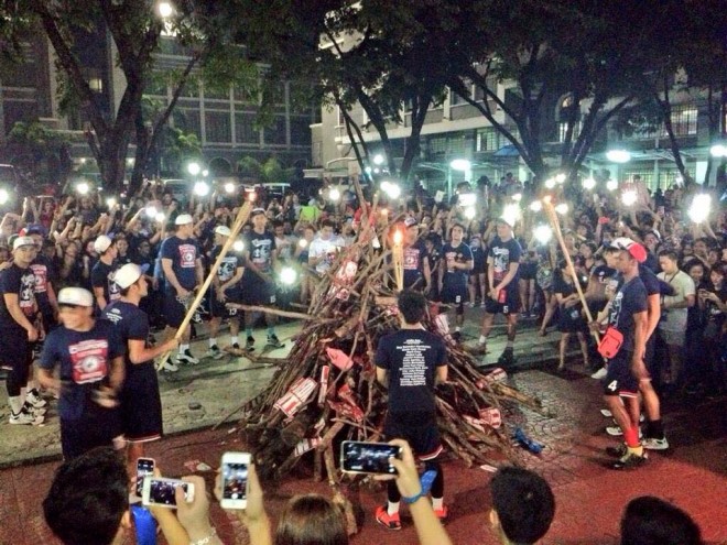 LETRAN basketball players about to light the bonfire