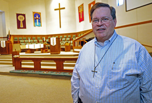 In this April 9, 2016 photo, senior pastor Warren Coile, of St. Mark's United Methodist Church poses for a photo in Brandon, Miss.  Coile believes that the diversity of any church can be a strength-even if there are honest, passionate disagreements about strongly-held beliefs. Among the church's members are a same sex couple and their daughter, who often attend the same services as does Mississippi's Republican Gov. Phil Bryant, who recently signed House Bill 1523, legislation that will allow government workers, religious groups and some private businesses to cite deeply held religious beliefs to deny services to lesbian, gay, bisexual and transgendered people. (AP Photo/Rogelio V. Solis)