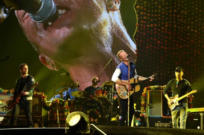 PASADENA, CA - AUGUST 20: (L-R) Musicians Guy Berryman, Will Champion, Chris Martin and Jonny Buckland of Coldplay perform at the Rose Bowl on August 20, 2016 in Pasadena, California.   Kevin Winter/Getty Images/AFP