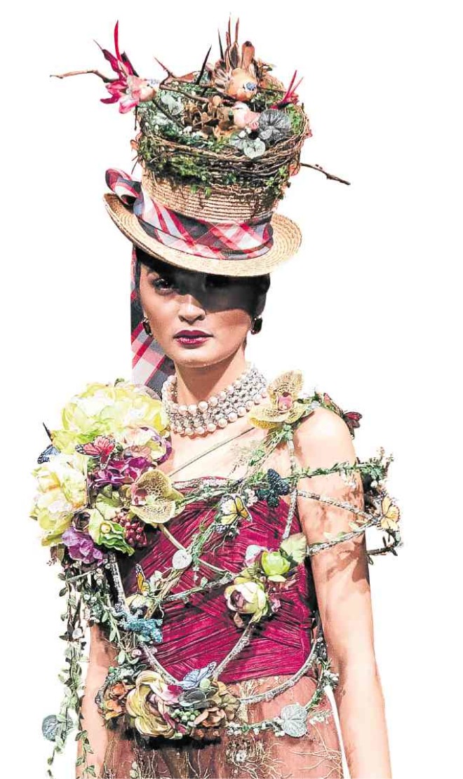 Passing theHat: “I loved making this hat with a nest of canary birds with colored Easter eggs. A body bracewith cabbage roses and jewels is my kimona.”