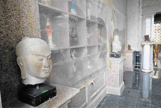 Buddha heads and various figurines from the Adarna couple’s extensive travels (above); engraved moldings on the vaulted ceilingwere inspired by the temples of India.
