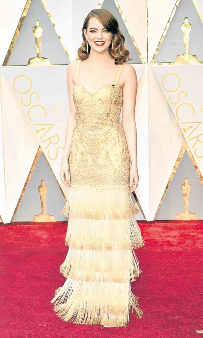 Flapper. Best Actress Emma Stone shimmers in Givenchy by Riccardo Tisci, perhaps his last for the brand.