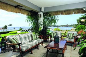 REACH THE BEACH: The living room, like many parts of the house,  looks out into the sea. Dried cogon fringes  enhance the place’s tropical feel.