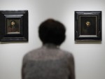 In this Monday, Aug. 1, 2011 photo, a person views two paintings attributed to Rembrandt van Rijn at the “Rembrandt and the Face of Jesus” exhibit. AP Photo/Matt Rourke