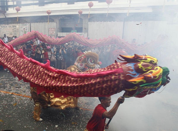 Firecrackers explode as Filipino-Chinese perform the dragon dance in celebration of the Chinese New Year at Manila's Chinatown district Monday. Jan. 23, 2012. in the Philippines. This year is the Year of the Dragon in the Chinese calendar. AP PHOTO/BULLIT MARQUEZ