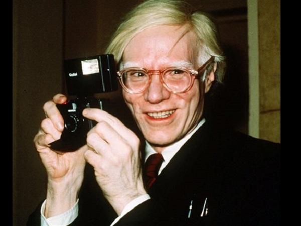 In this 1976 file photo, pop artist Andy Warhol smiles in New York. The Andy Warhol Museum is launching a live video feed from the pop artist’s gravesite to honor his 85th birthday. Warhol’s 85th birthday would have been Tuesday, Aug. 6, 2013. Warhol died in 1987. AP