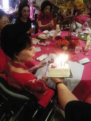 IMELDA Cojuangco blows her birthday cake surrounded by family and close friends. Right:With son Choy Cojuangco