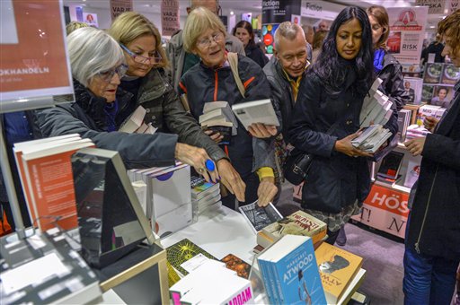 The last copy of French writer Patrick Modiano's book "L'herbe des nuits", centre, is taken from the table at a Stockholm bookstore minutes after Modiano was declared the winner of the 2014 Nobel Prize in Literature Thursday Oct. 9, 2014, in Stockholm, Sweden. The Nobel Prize for Literature was awarded 'for the art of memory with which he has evoked the most ungraspable human destinies and uncovered the life-world of the occupation,' the Swedish Academy said. (AP Photo / Henrik Montgomery)  SWEDEN OUT