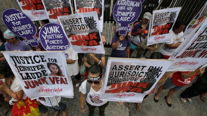 Protesters, mostly supporters of LGBT (Lesbians Gays Bisexuals and Transgenders) display their messages during a rally at the Department of Foreign Affairs to demand justice for the killing of Filipino transgender Jeffrey "Jennifer" Laude with a U.S. Marine as a possible suspect Wednesday, Oct. 15, 2014 at suburban Pasay city, south of Manila, Philippines. The activists demanded that Washington hand over to the Philippines a Marine implicated in the killing of Laude which the demonstrators labeled a hate crime. (AP Photo/Bullit Marquez)