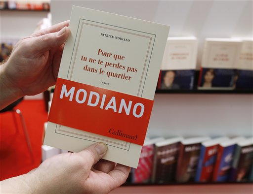 A man holds a book of French author Patrick Modiano at the Book Fair in Frankfurt, Germany, Thursday, Oct. 9, 2014. Modiano won this year's nobel prize for literature. AP