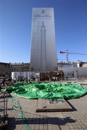 The controversial inflatable statue "Tree" by U.S. artist Paul McCarthy as part of the International Modern Art Fair (FIAC), sits deflated on the Place Vendome in Paris, France, Saturday, Oct. 18, 2014. AP