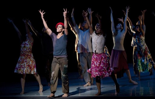 John Lobo, 29, wearing a red beret performing as Venezuela's late president Hugo Chavez, performs in the "Ballet of the Spider-Seller to Liberator" at the Teresa Carreno Theater in Caracas, Venezuela, Thursday, Nov. 27, 2014. (AP Photo/Ariana Cubillos)