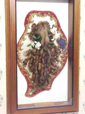 Framed beside Thérèse’s bed are ringlets of her long hair.