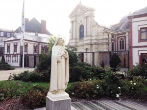 A STATUE of Thérèse stands in the small square in front of the Carmel, the convent where she lived and died.