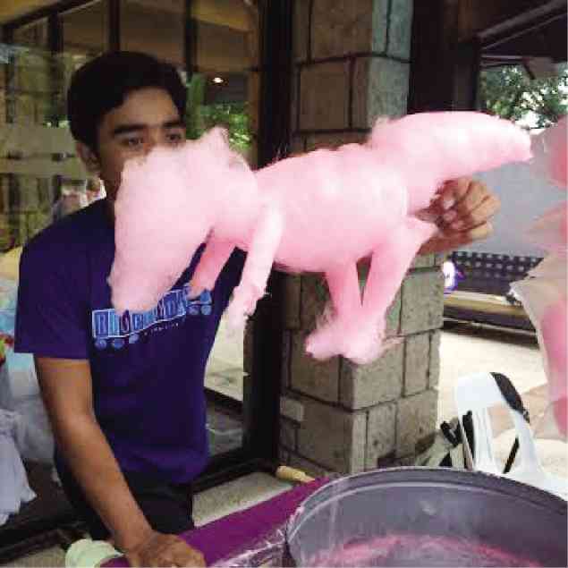 ARNOLD Castro with a cotton candy dinosaur