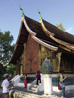 THE 16TH-CENTURYWat Xieng Thong, shown here with a glass mosaic of the Tree of Life and gilded carved wood ANNE A. JAMBORA