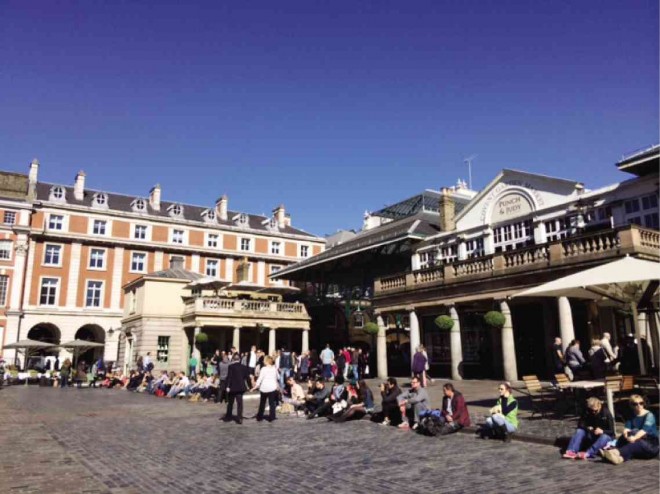 LONDONERS and visitors take advantage of the summer sun at Covent Garden