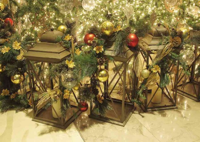 INSTEAD of 12 gifts at the bottom of the tree, traveler’s lamps with balls and garlands form the base