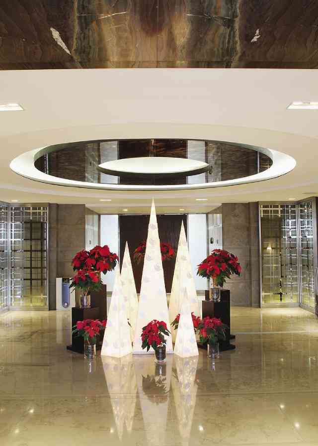 POINSETTIAS add color at the lobby display of pyramid trees.