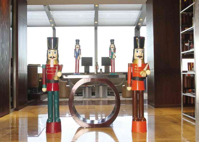 FIBERGLASS pipers welcome guests on the 44th floor.