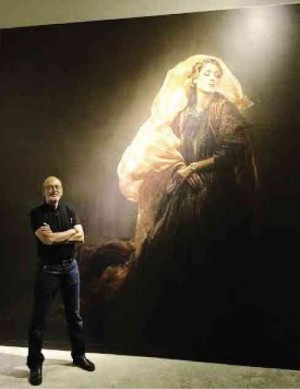 NATIONAL Artist BenCab stands before themural of “Sabel” fashion photograph, as preparations run deep into the night.
