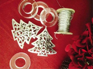 Old Christmas tree ornaments and napkin holders and shiny strings to be used for Yuletide table setting.