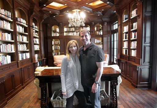 In this photo taken on Feb. 21, 2012, Nicholas Sparks, right, and his wife, Cathy, pose inside their Trent Woods, North Carolina, home. Spokeswoman Jill Fritzo of PMK-BNC confirmed Tuesday, Jan. 6, 2015, that the best-selling author and screenwriter had separated from his wife of 25 years, Cathy.  AP PHOTO/THE NEW BERN SUN JOURNAL, CHUCK BECKLEY