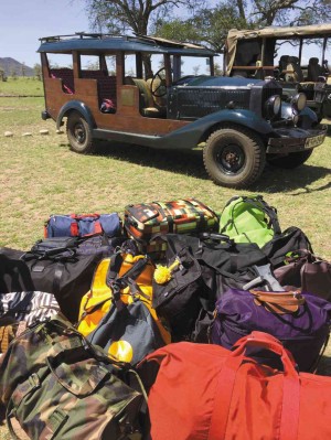 OUR TROUPE’S luggage next to vintage game drive cars