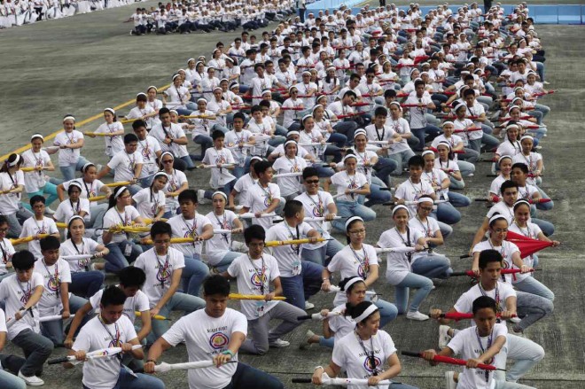 DANCERS holding red, white, yellow and blue umbrellas prepare for their Philippine flag formation.