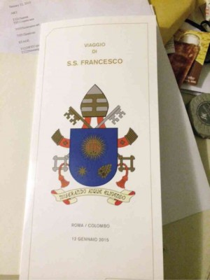 ALITALIA menu card for papal flight shows Pope Francis’ coat of arms with motto.