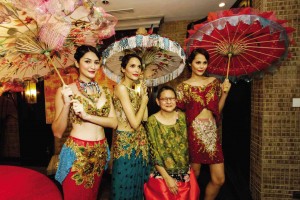 FASHION designer Patis Pamintuan Tesoro (seated) and a preview of her “La Collection Rouge” show for Sofitel on Feb. 17