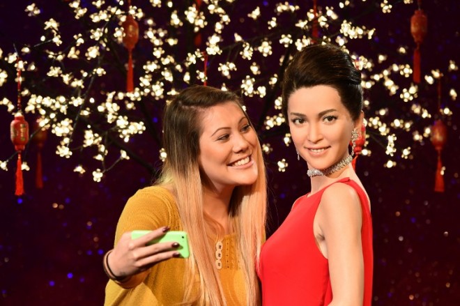 Helen Smith, a fan of the Chinese actress Li Bing Bing, poses with a wax figure of the Chinese actress unveiled to kick off London's Chinese New Year celebrations at Madame Tussauds in central London on January 29, 2015. The Chinese lunar New Year, ushering in the Year of the Sheep, begins on February 19. AFP