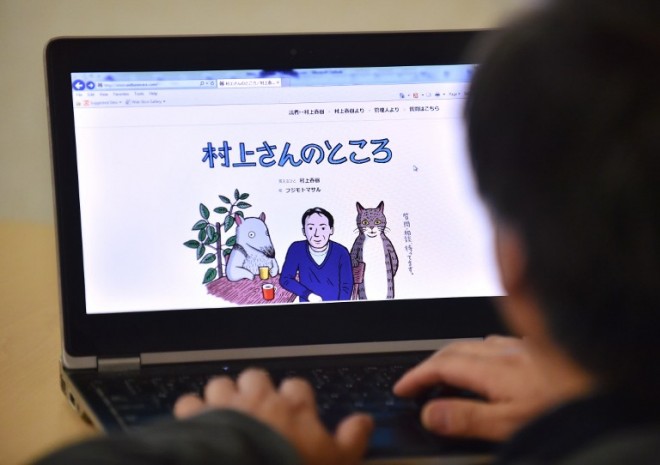 This photo illustration shows a man looking at newly opened website "Murakami-san no tokoro" or "Mr. Murakami's place" illustrated by artist Masaru Fujimoto, in Tokyo on Jan. 16. AFP