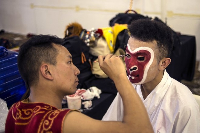 Artists wear make-up before a reharsal for the celebrations of the upcoming Chinese New Year at the Brightwater Commons shopping center in Johannesburg on February 1, 2015. The New Year of the goat will start on February 19, 2015.  AFP