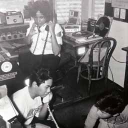 RADYO BANDIDO Radio-TV personality June Keithley receives instructions from Fr. James Reuter, while holding fort at Radyo Bandido, aka rock station dzRJ, which was used to broadcast the Edsa revolt live.