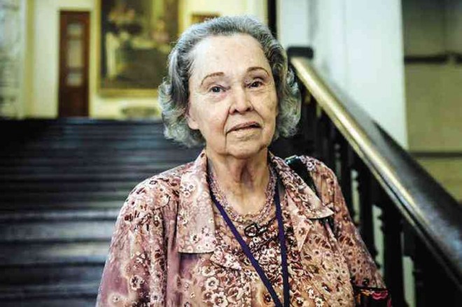 CHAPMAN before “the big, wide wooden staircase” at the UST Main Building. She says the Japanese had planned to blow off the camp with its internees. “This is the stairs where I am supposed to die,” she declares.
