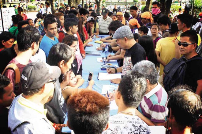 FILIPINO visual artists hold caricature sessions at Luneta Park.