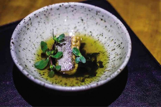 DELICATE grouper perched on a bed of wakame and garnished with purslane floats in a clear kamias and guava broth
