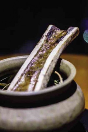 RICH bone marrow is smoked over palay and black rice on charcoal in a handmade pottery bowl.