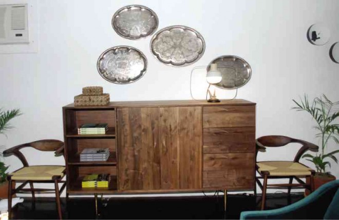 COPPER and silver plates from Copenhagen play against the wooden cabinet from Organic Modern.