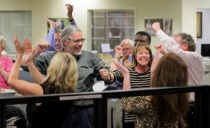The Post and Courier staff cheers after the Pulitzer prize announcement Monday, April 20, 2015 in its Charleston, S.C. The newspaper was awarded a Pulitzer Prize for Public Service for its series on domestic violence. The Public Service gold medal went to reporters Doug Pardue, Glenn Smith, Jennifer Berry Hawes and Natalie Caula Hauff for the series Till Death Do Us Part. The series explored the deaths of 300 women in the past decade and a legal system in which abusers face at most 30 days in jail if convicted of attacking a woman, while cruelty to a dog can bring up to five years in prison.   ( Grace Beahm/The Post And Courier via AP)