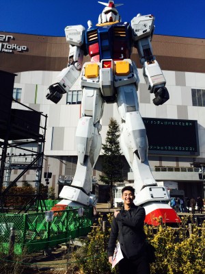 THE AUTHOR posing with the giant Gundam in Odaiba