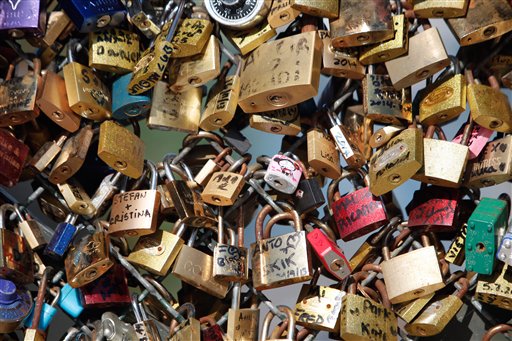 This April 9, 2014 file photo shows love locks fixed on the Pont des Arts bridge in Paris, France.  AP