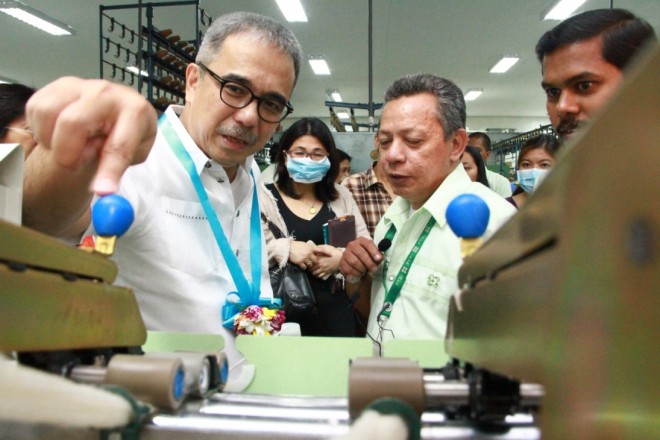 Department of Science and Technology (DOST) Secretary Mario G. Montejo (left) examines one of the newly acquired equipment for the  Innovation Center for Yarns and Textiles during its launching last May 25, 2015 at DOST’s Philippine Textile Research Institute (PTRI) in Bicutan, Taguig City. PHOTO FROM DOST.GOV.PH